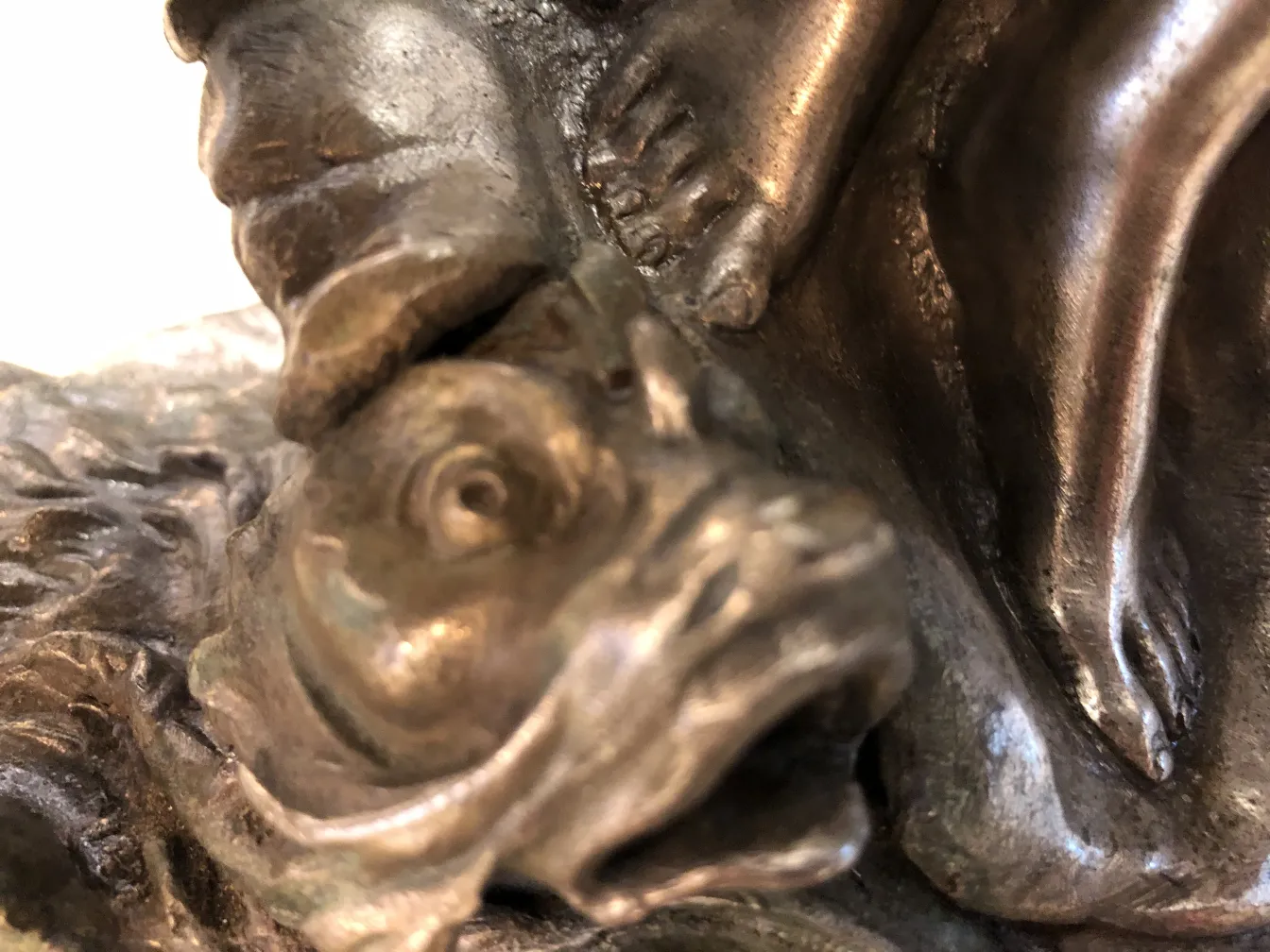 centro de mesa antigo com design em relevo de um peixe e um pé humano