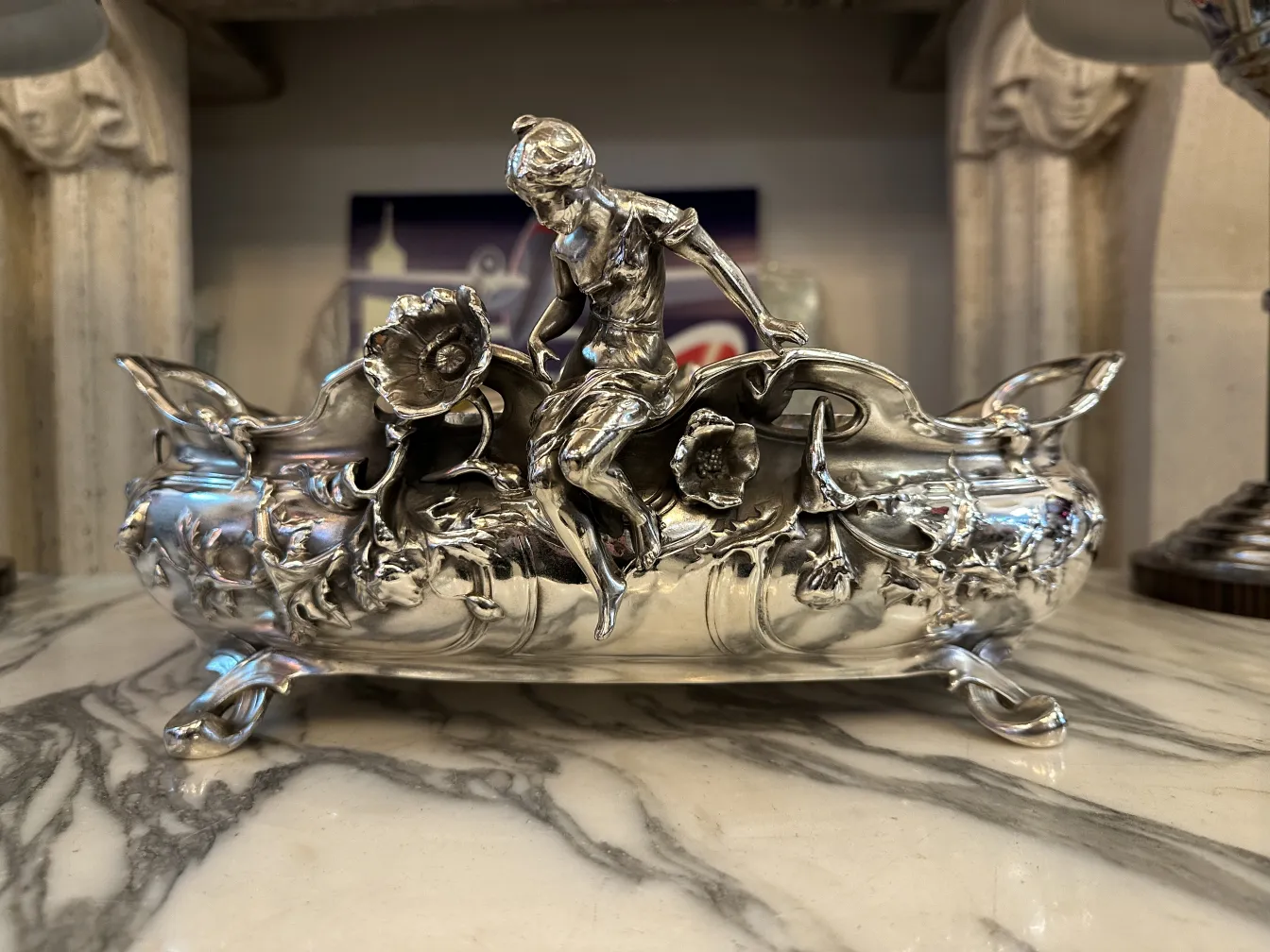 antique centerpiece featuring a decorative figure and flowers