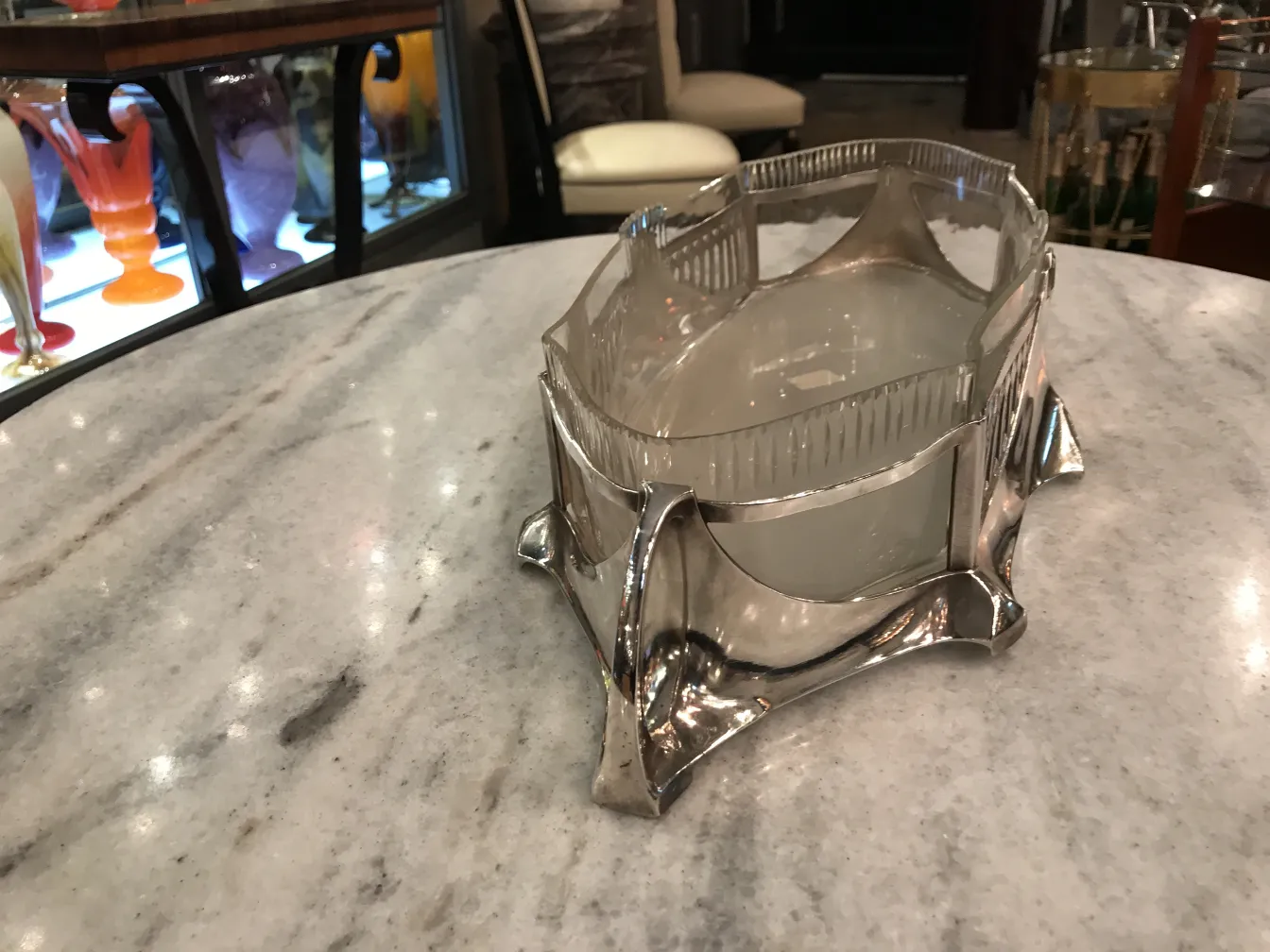 antique WMF centerpiece with a unique design on a marble table.