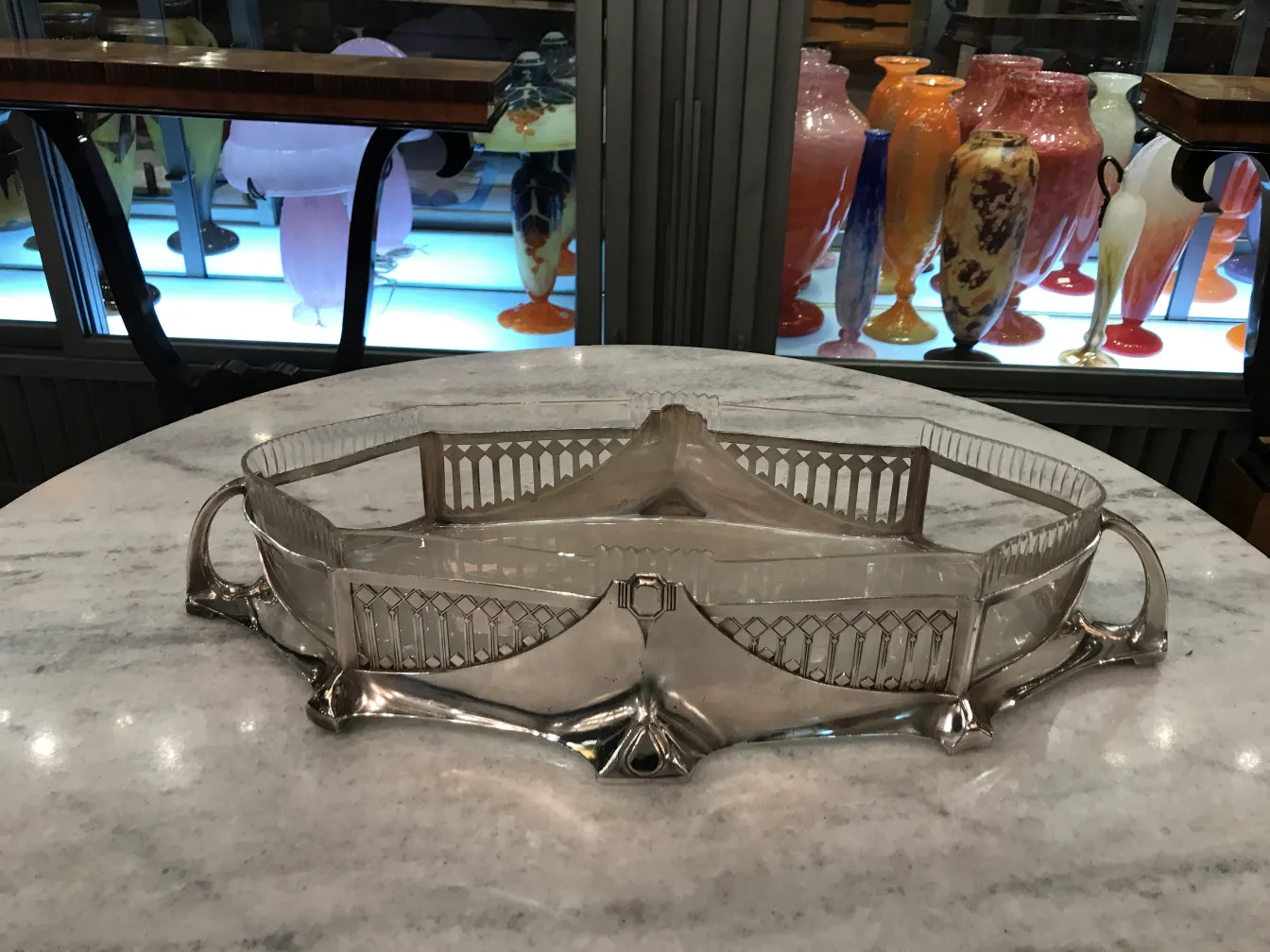 antique WMF centerpiece with elegant design, surrounded by antiques