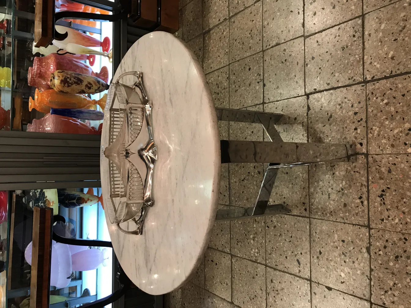 wmff centerpiece on round table, decorative with elegant style, in an antique setting.