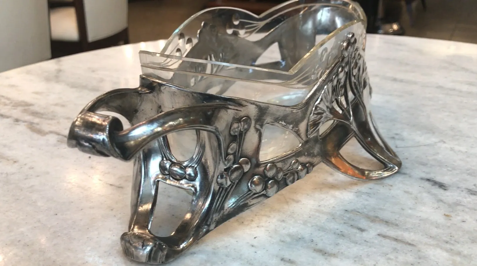 Antique WMF centerpiece with ornamental design, enhancing a table setting.