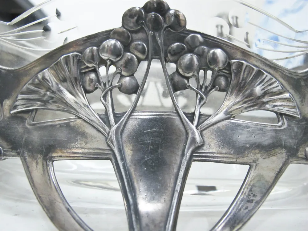 Antique WMF centerpiece with floral design, set in an elegant atmosphere.