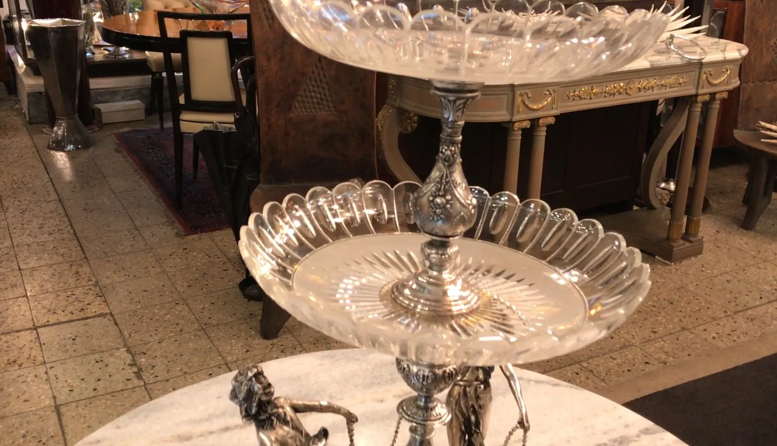 wmff centerpiece with two tiers and decorative details, in an antique setting