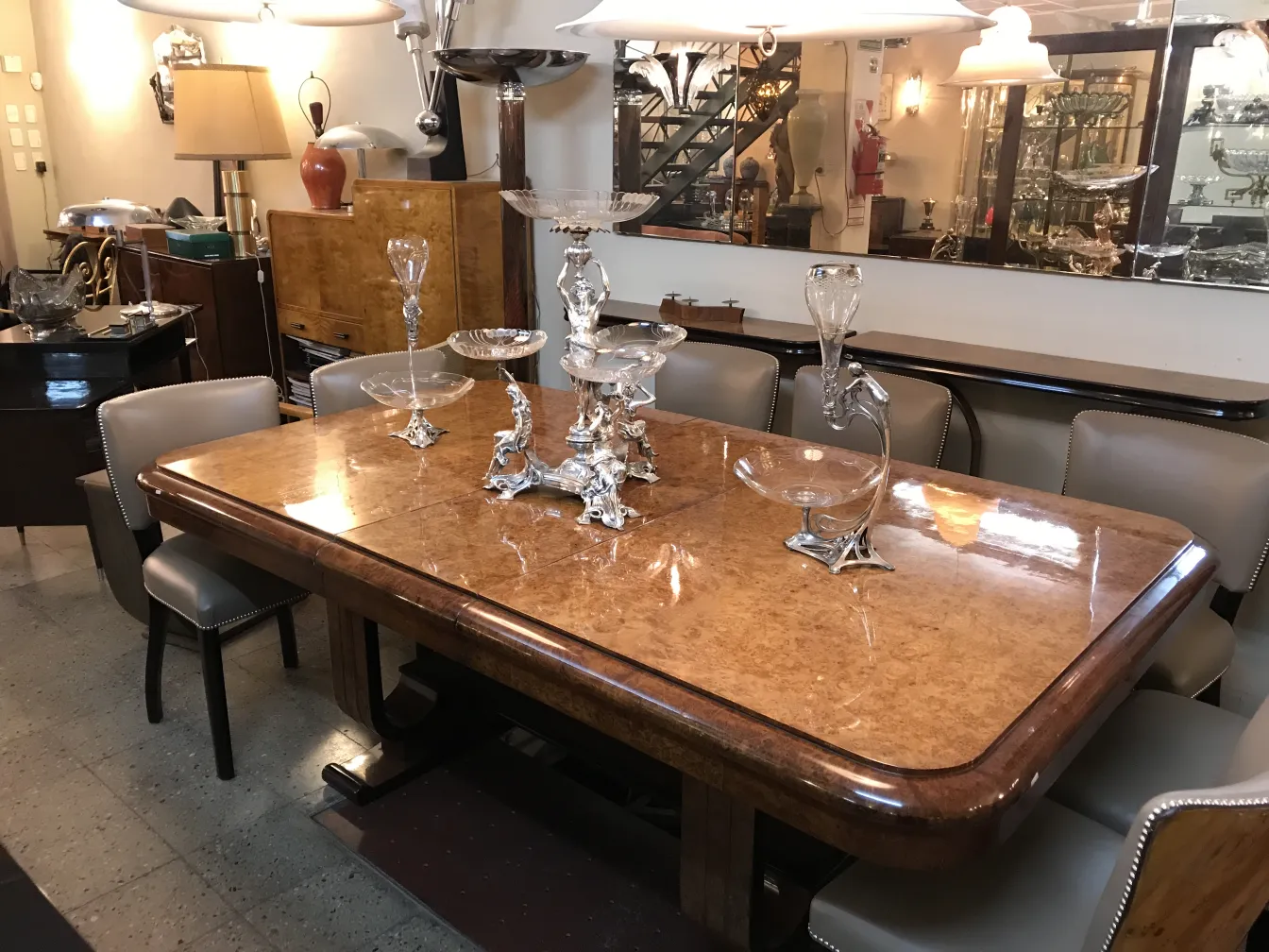 Antique WMF centerpiece adorning an elegant table, surrounded by glassware and antique furniture.