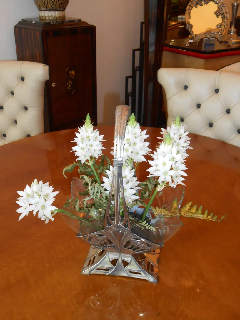 antique WMF centerpiece with white flowers on a table