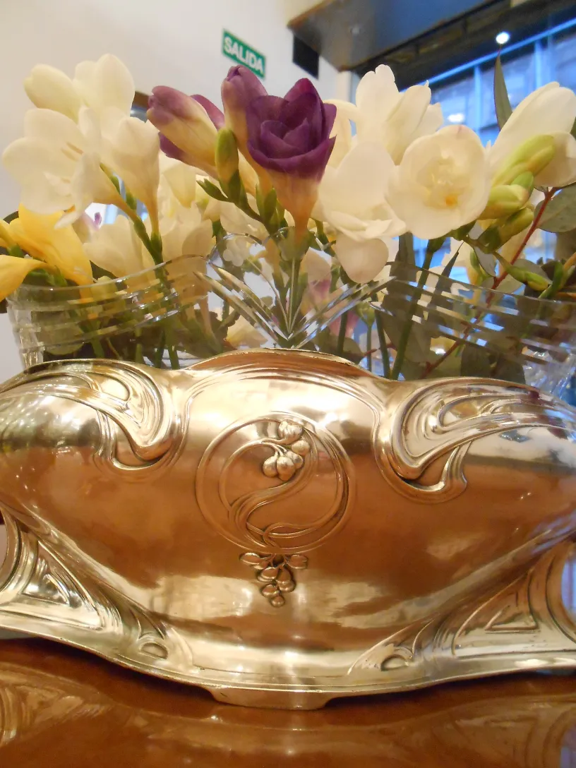 antique centerpiece wmf adorned with colorful flowers