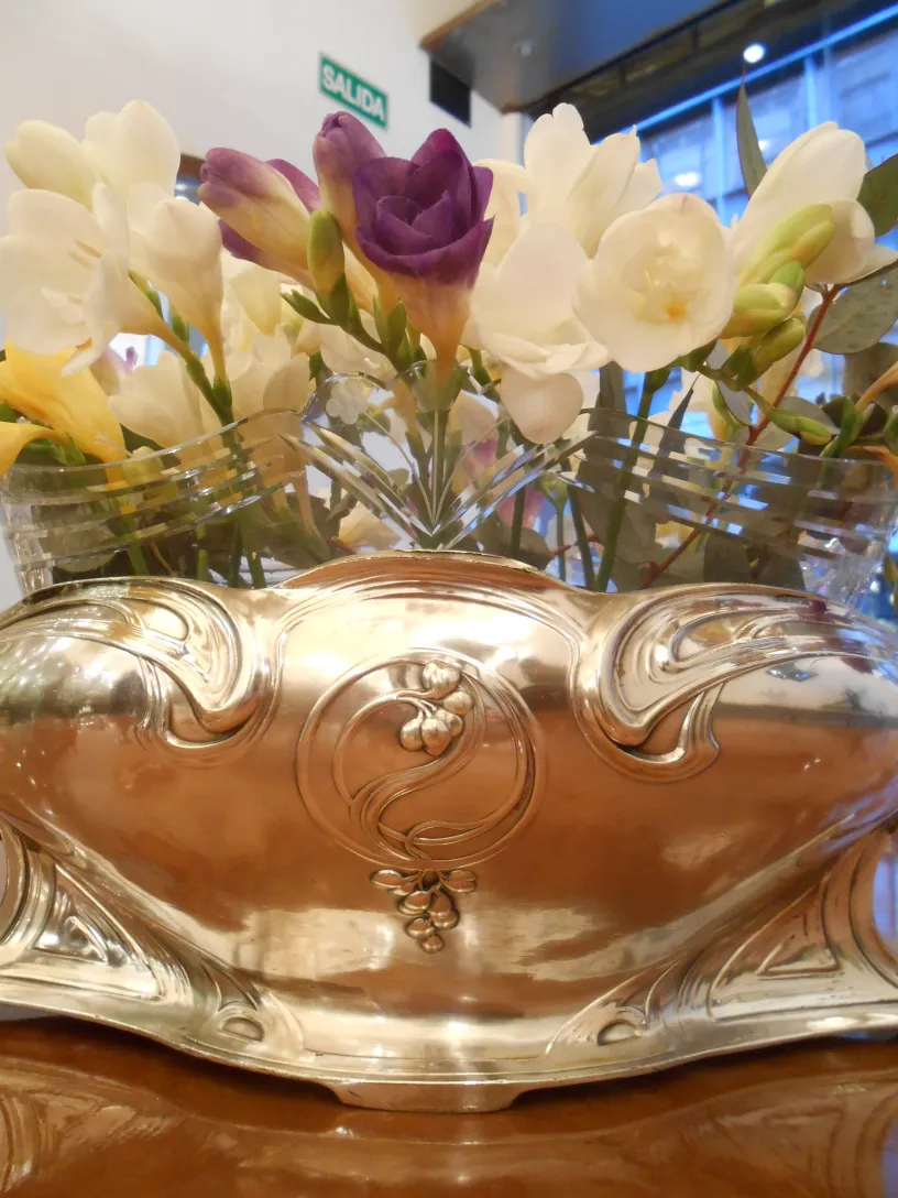 antique wmf centerpiece adorned with colorful flowers in a cozy setting