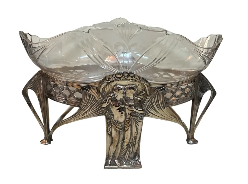 Centrotavola WMF con base decorativa, stile antico e forma scolpita elegantemente.