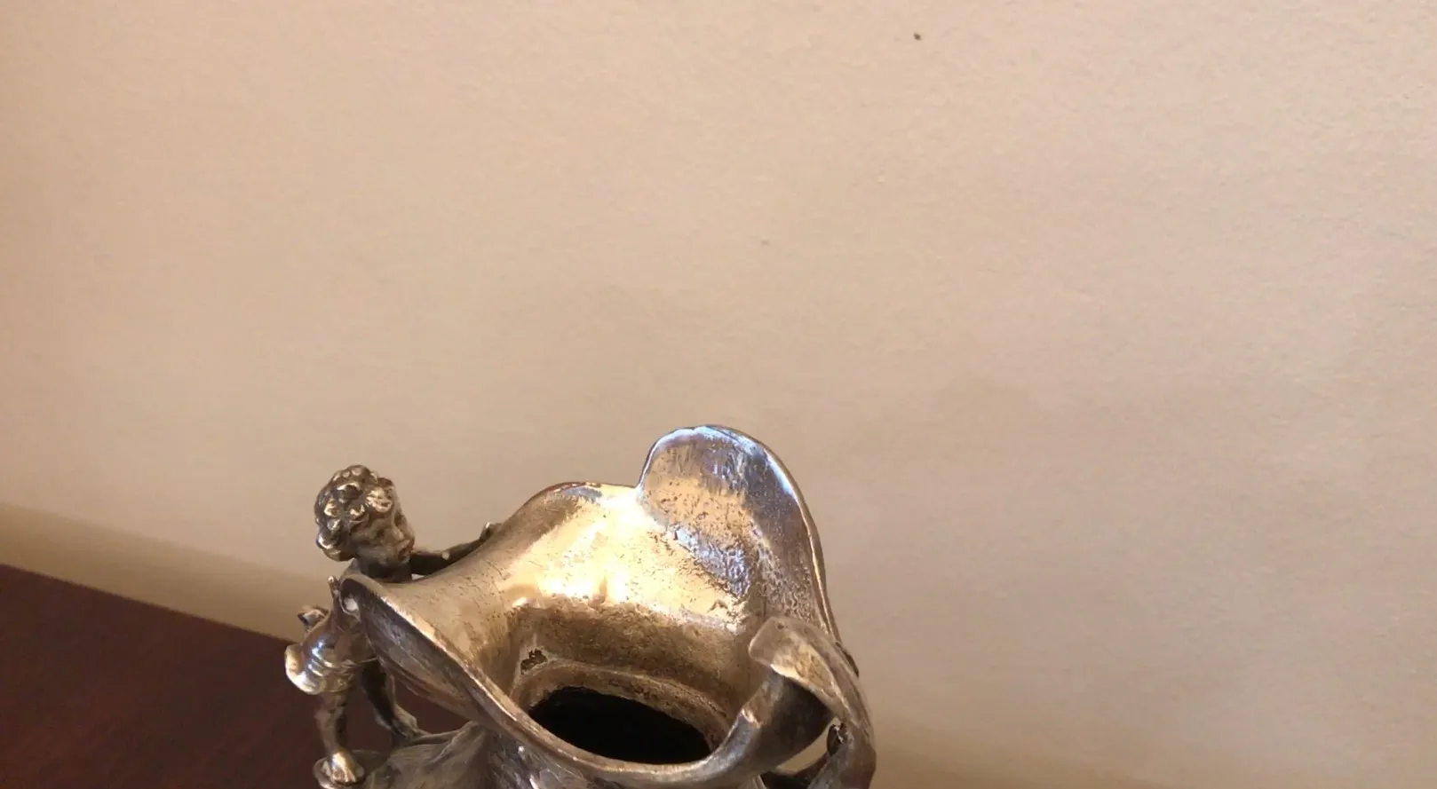 antique jar featuring decorative figures and elegant shapes