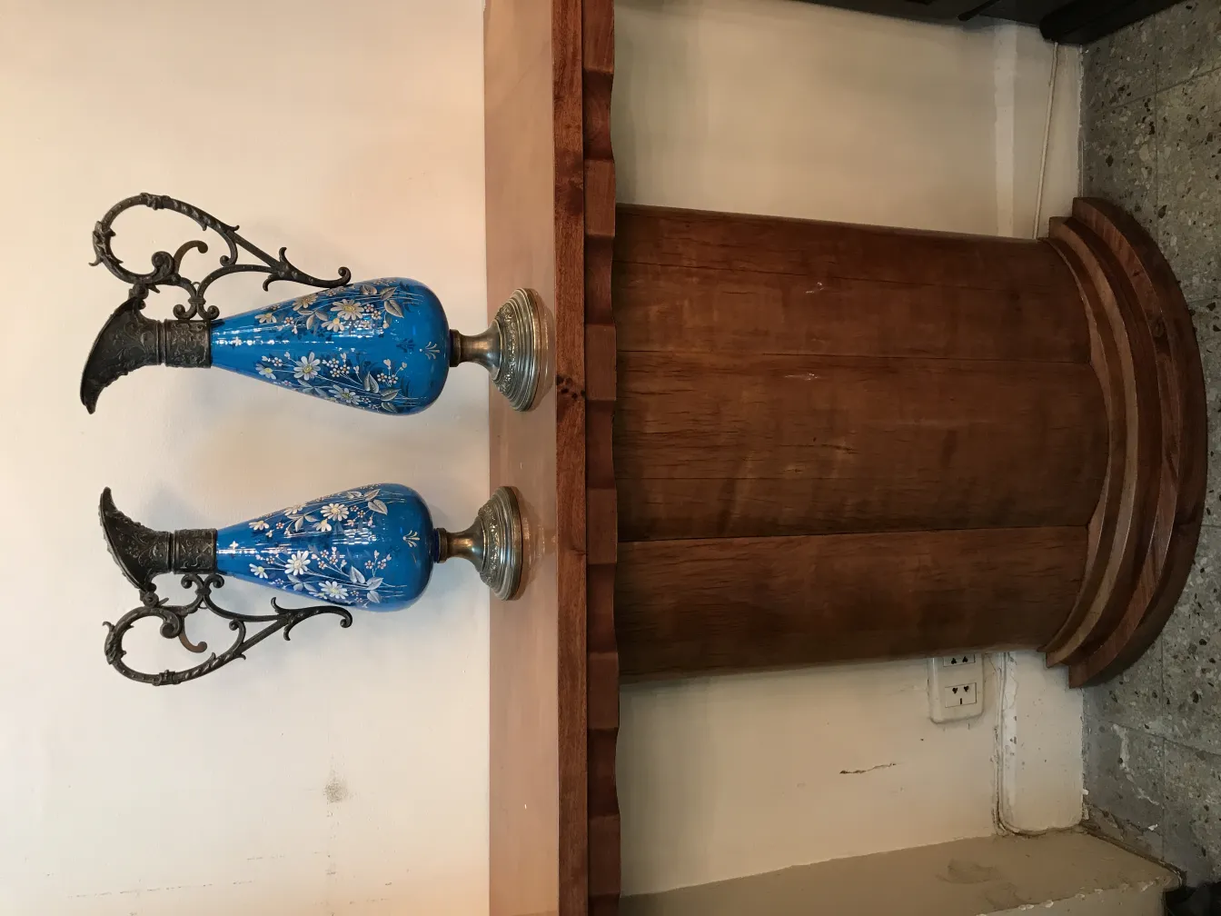 Two antique WMF jars with floral designs on a light background