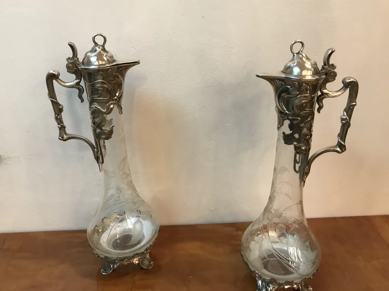 two ancient wmfs jars with decorative details on the handle