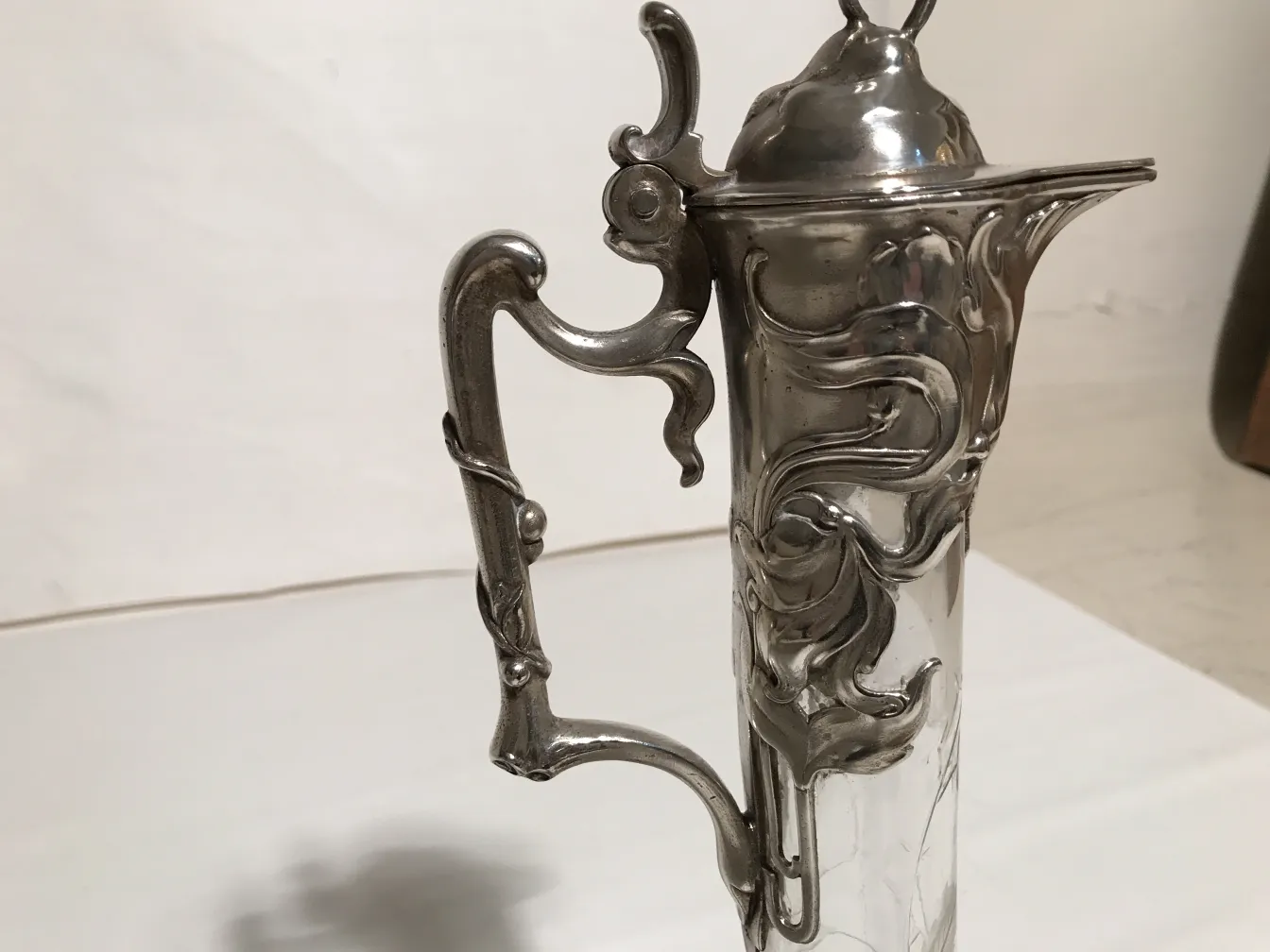 Two antique WMF jars featuring ornate floral designs.