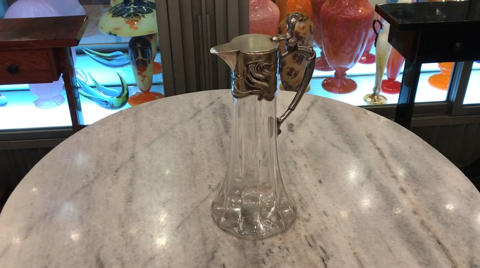 2 antique WMF jars on a marble table with other decorative items