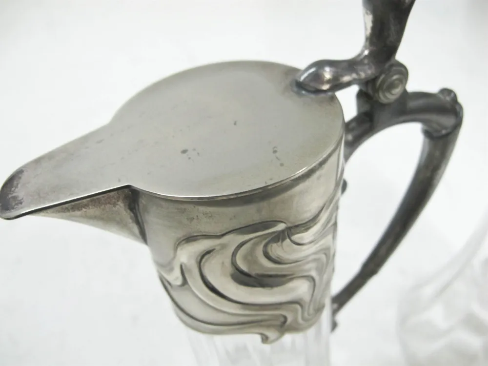 Detailed view of 2 antique jars wmff with elegant design and decorative handles in a classic setting.