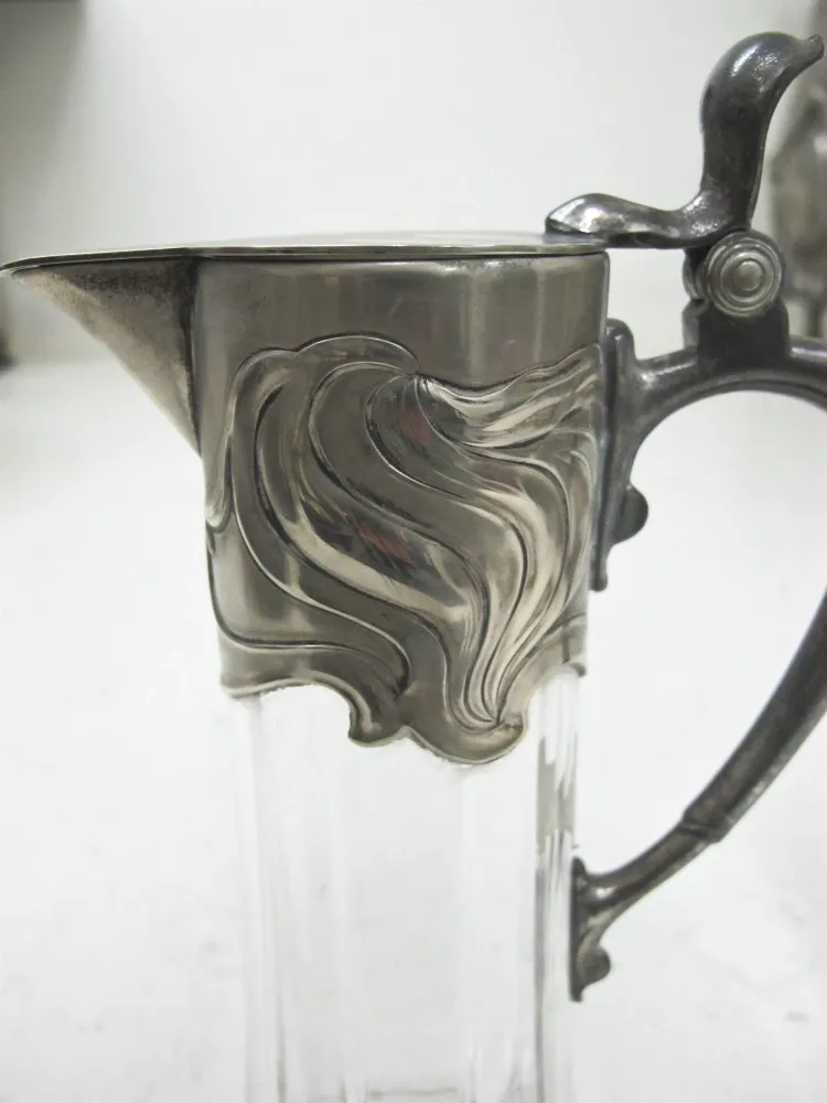 Two antique wmfs jars with an elegant design on the top and a stylish handle.