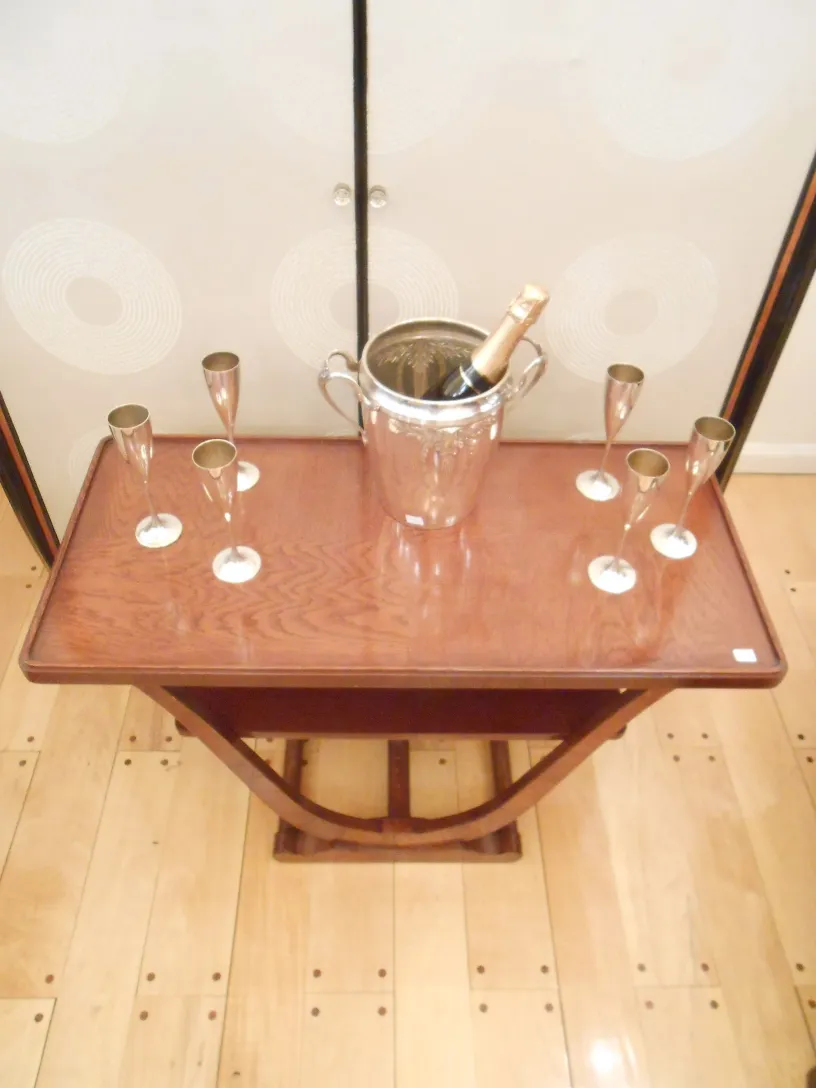 antique champagne cooler on a table with glasses and a bottle of champagne