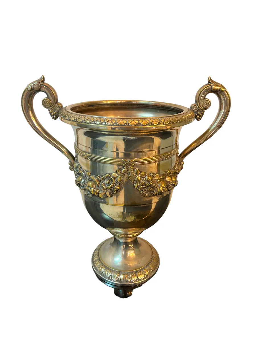 Image of two antique champagne coolers WMF with detailed decorations on their shiny surface.