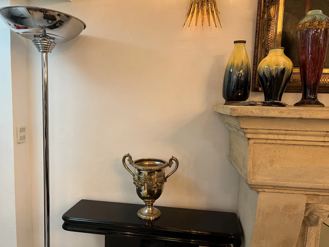 Two antique champagne coolers with decorative handles, in an elegant setting.