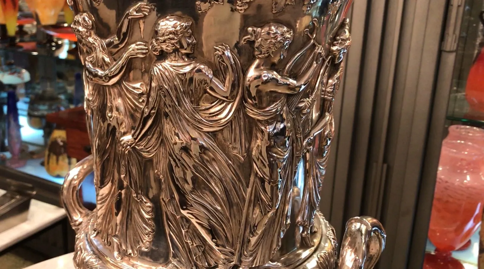 Antique champagne cooler with ornate relief details.