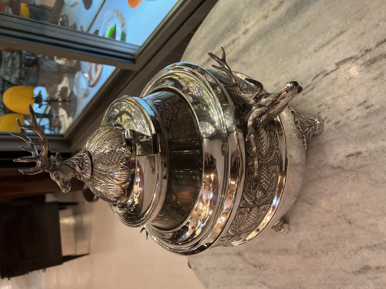 antique WMF punch bowl featuring a deer on the lid and decorative details on the base