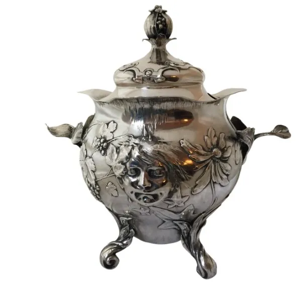 Antique WMF punch bowl with floral reliefs and human face, decorative.