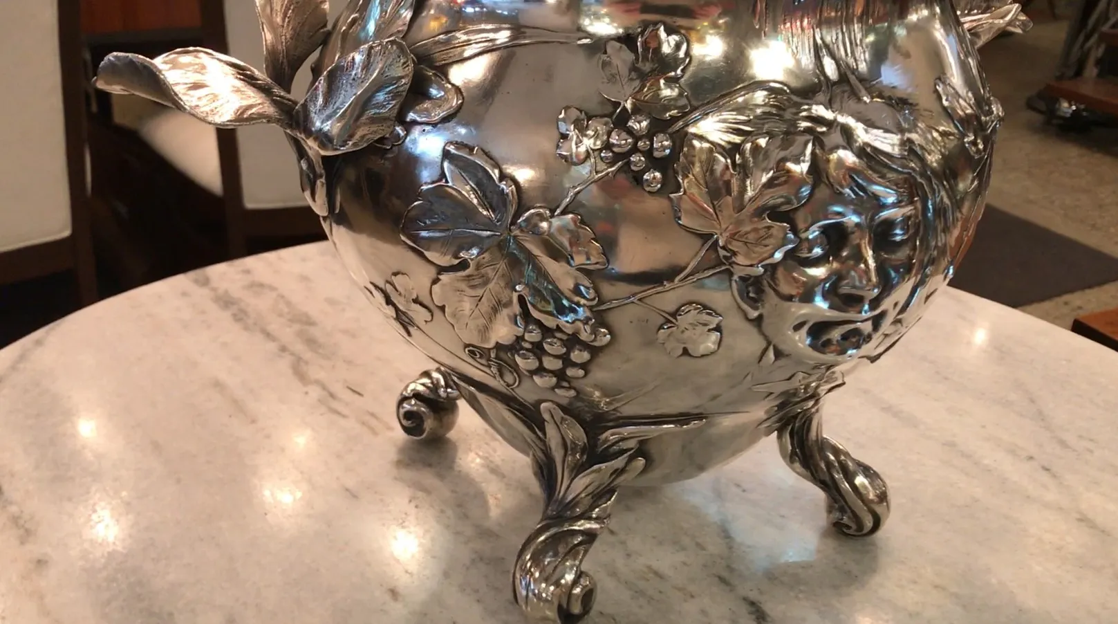 Antique WMF punch bowl with embossed leaf and grape details.