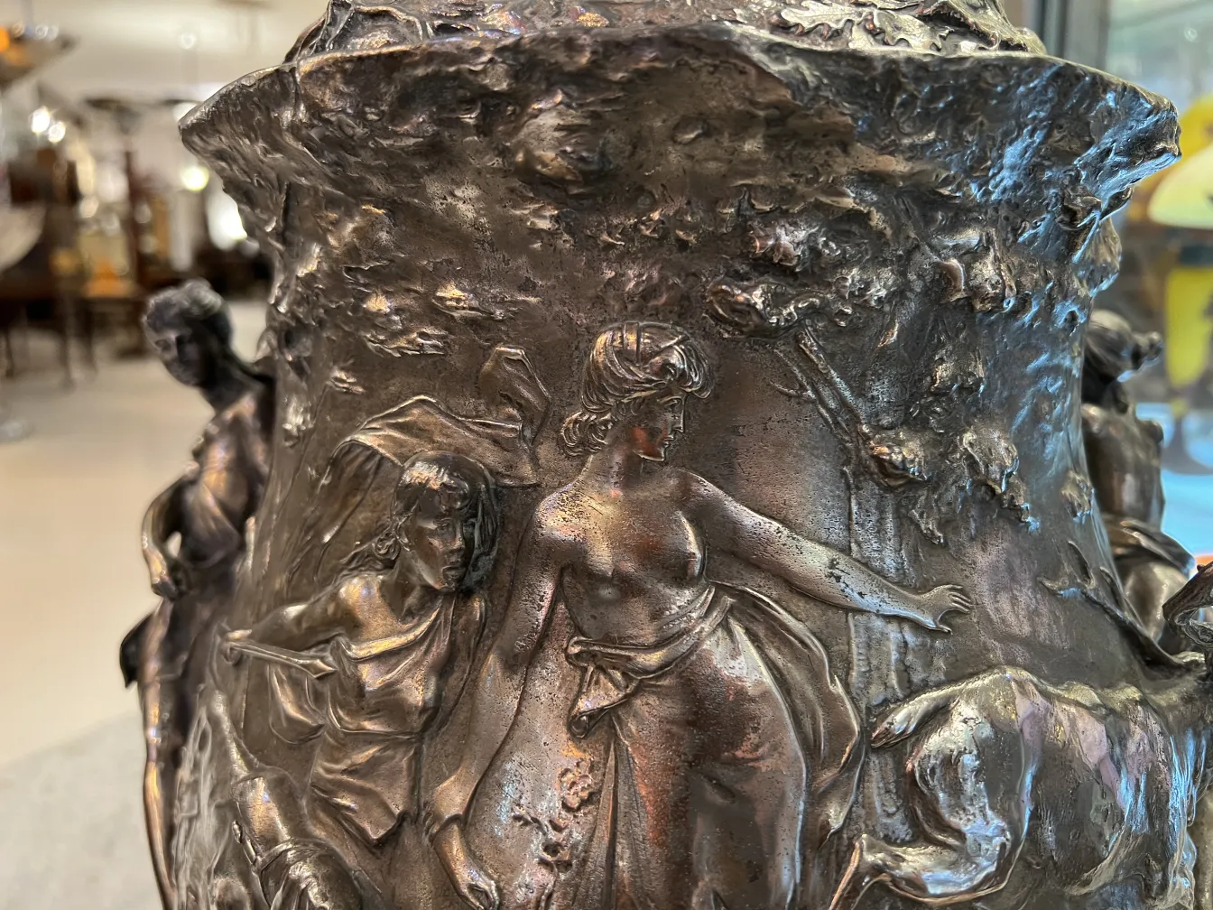 Antique WMF punch bowl featuring sculptural details on its surface, showcasing figures in relief.
