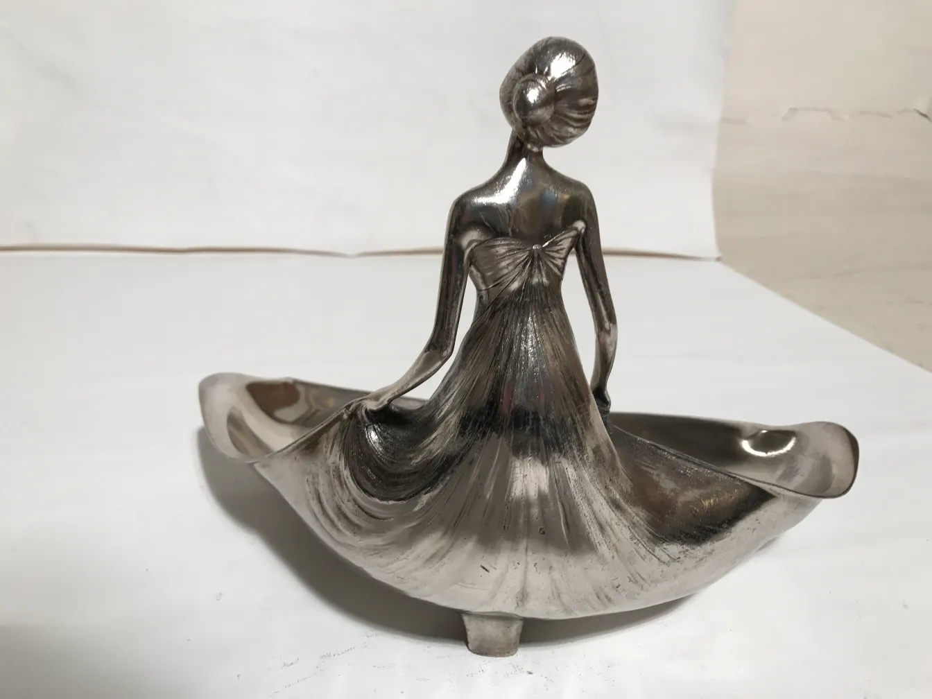 antique card tray orivit featuring a stylized figure