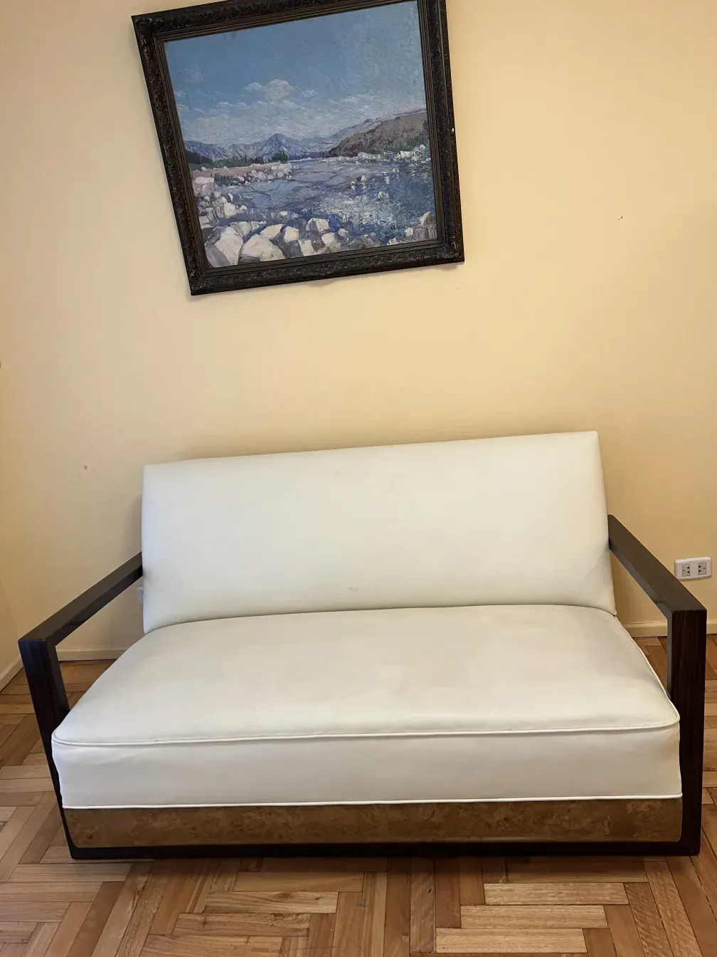 Sillón antiguo con detalles clásicos y unas formas elegantes, en una habitación iluminada.