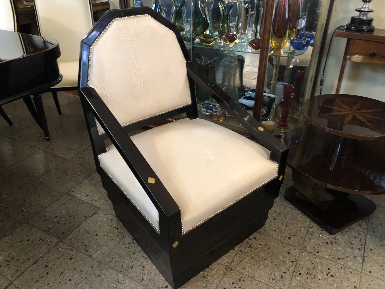 fauteuil ancien avec coussin clair et accoudoirs, environnement élégant