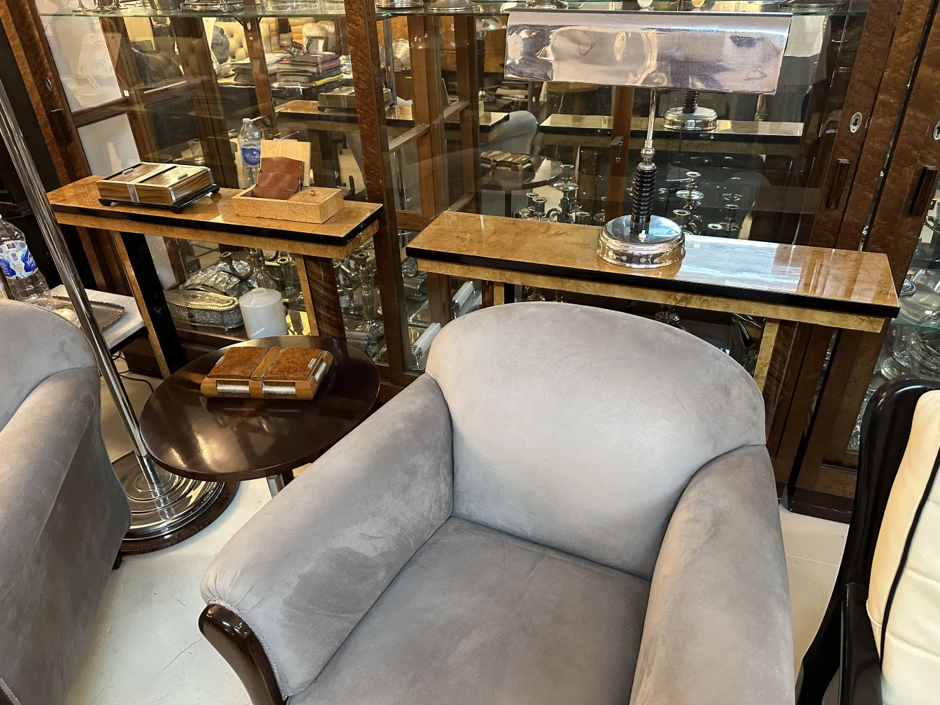 two antique armchairs in an elegant setting with a table and lamp