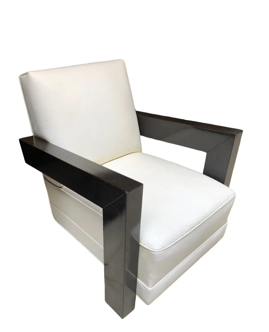 Two vintage armchairs with armrests and light upholstery.