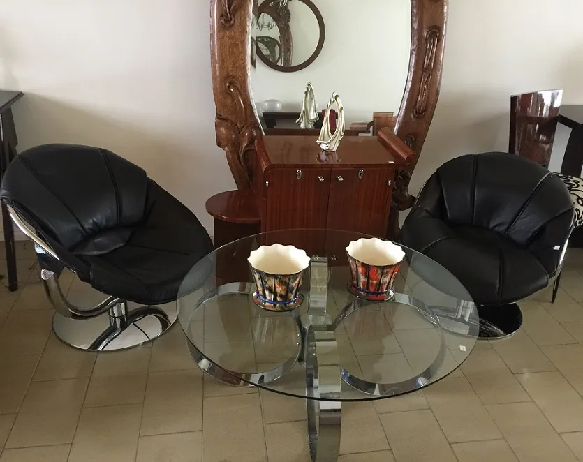 two antique armchairs in an elegant setting with a mirror