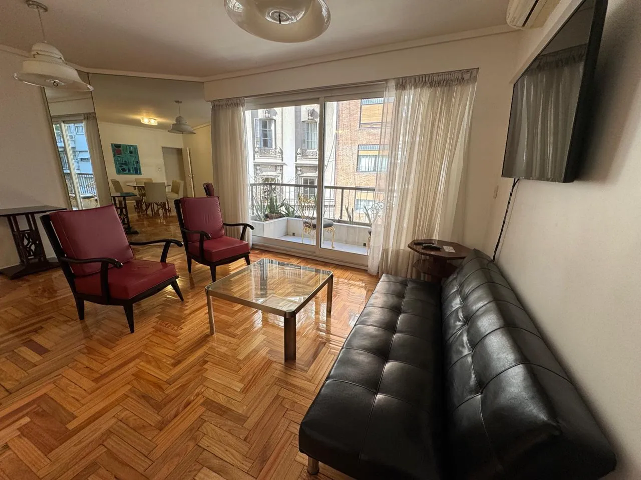 dos sillones rojos antiguos en un salón moderno