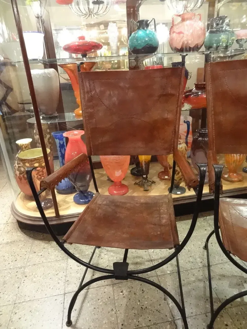 two antique armchairs in a decorative setting