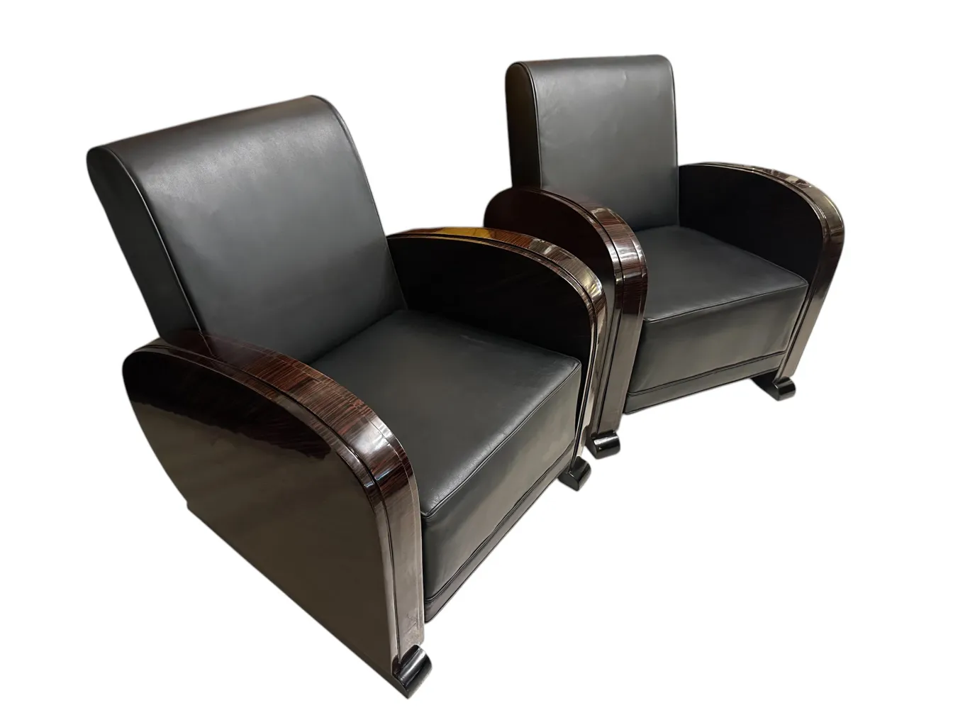 Two antique armchairs with elegant design in a classic setting.