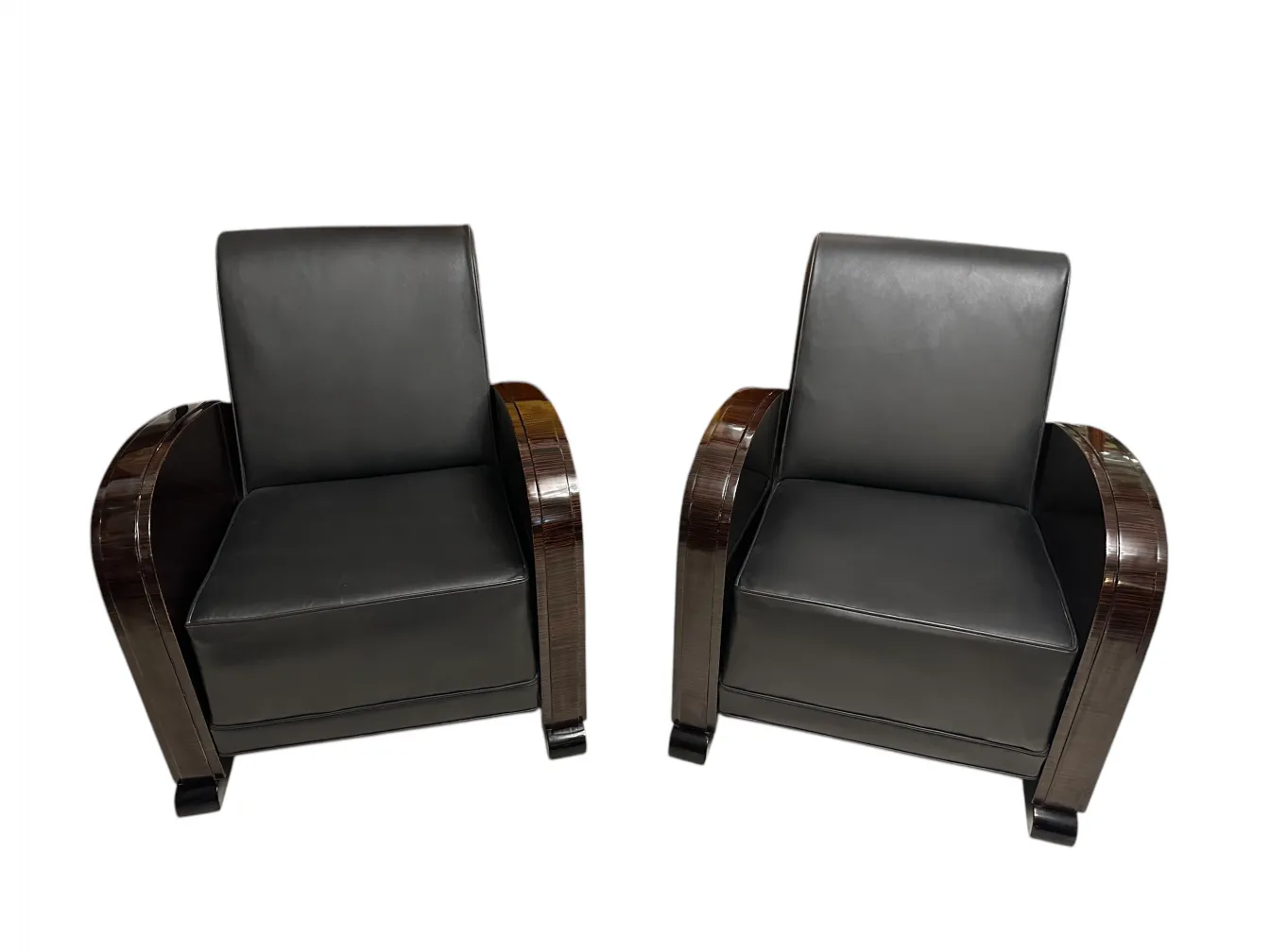 Two antique armchairs featuring a sophisticated and comfortable design