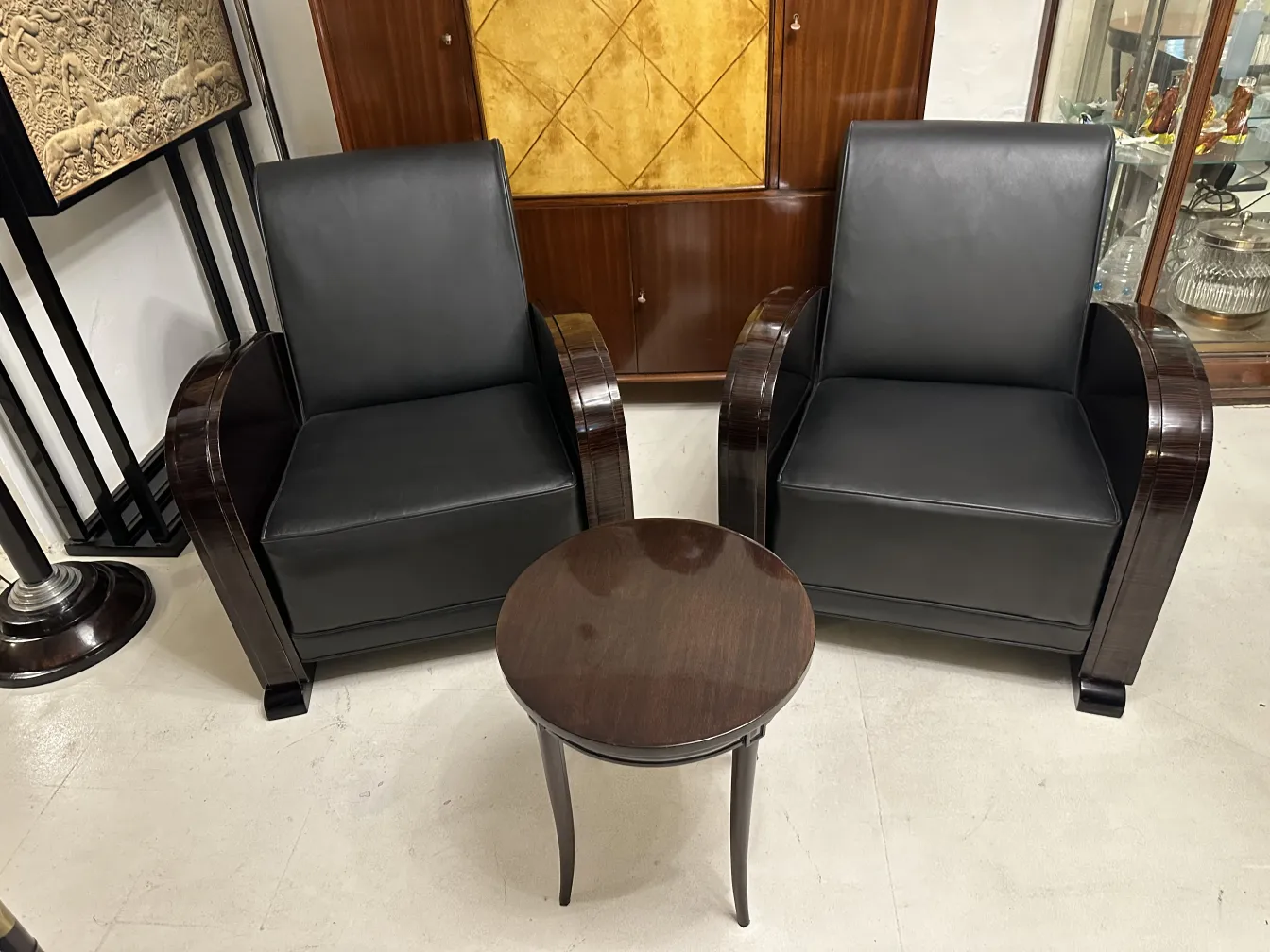 Two antique armchairs with elegant and comfortable black upholstery.