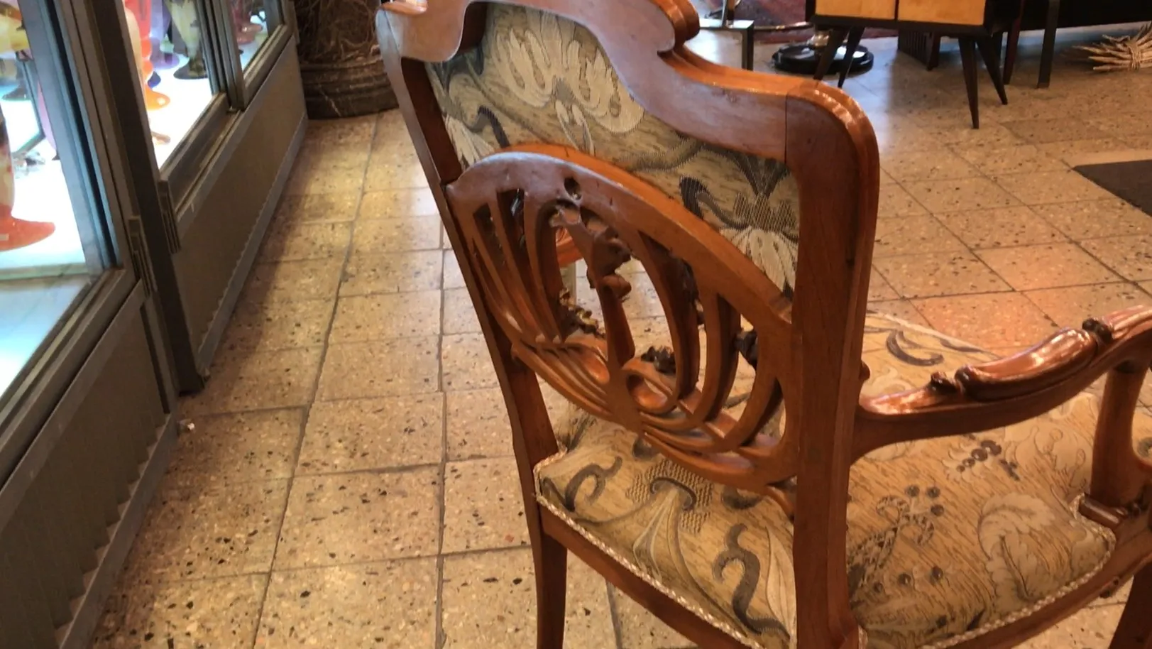 Vista di 3 poltrone antiche in un ambiente accogliente, con dettagli intricati e uno sfondo decorativo.