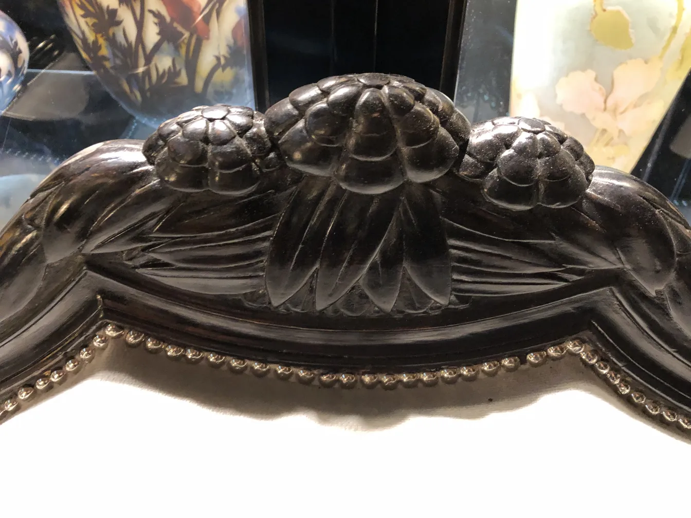 Detailed view of the top of 3 antique armchairs Paul Follot with floral motifs