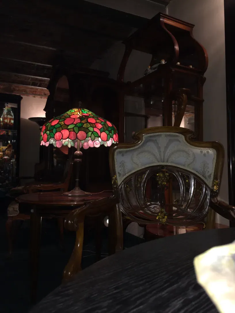 5 poltronas antigas com detalhes art nouveau em um ambiente elegante.