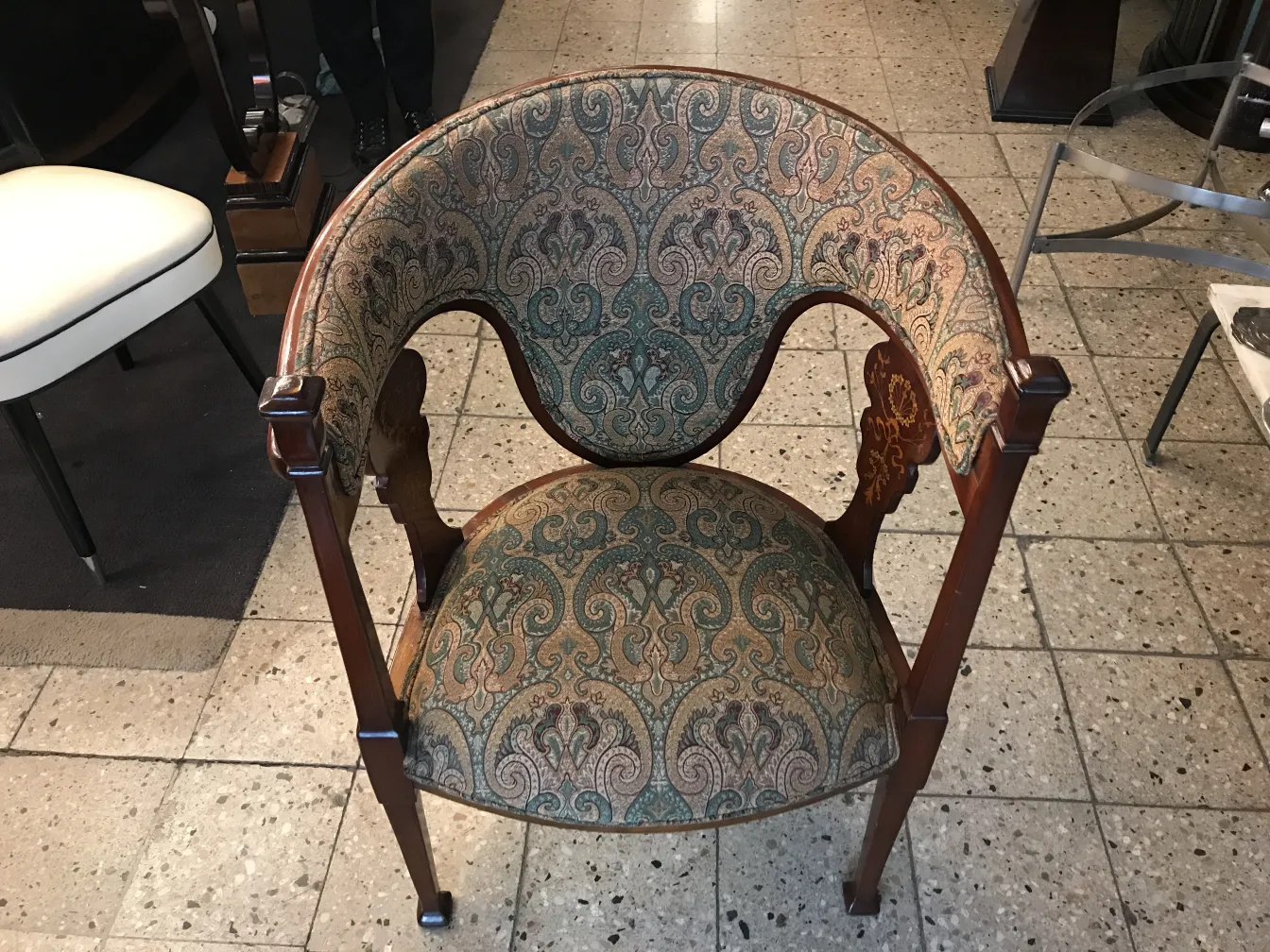 front view of an antique armchair with patterned fabric
