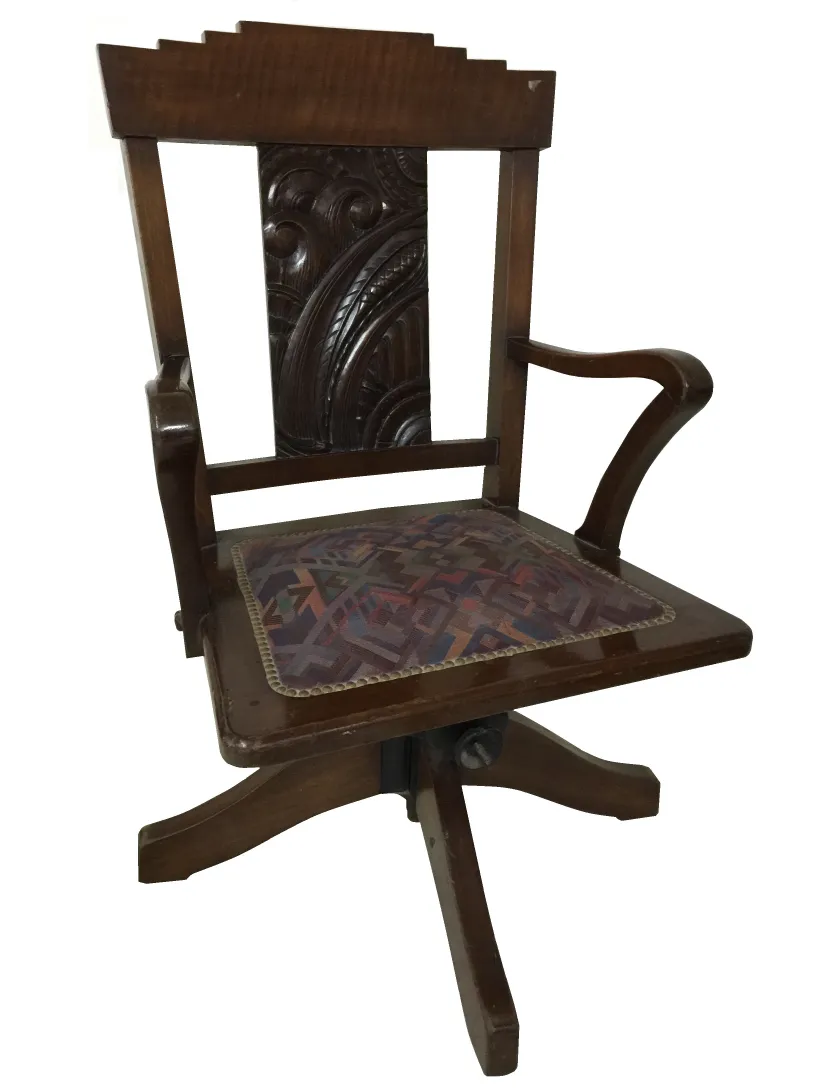 Antique desk chair with carved backrest and decorated seat, perfect for classic offices.