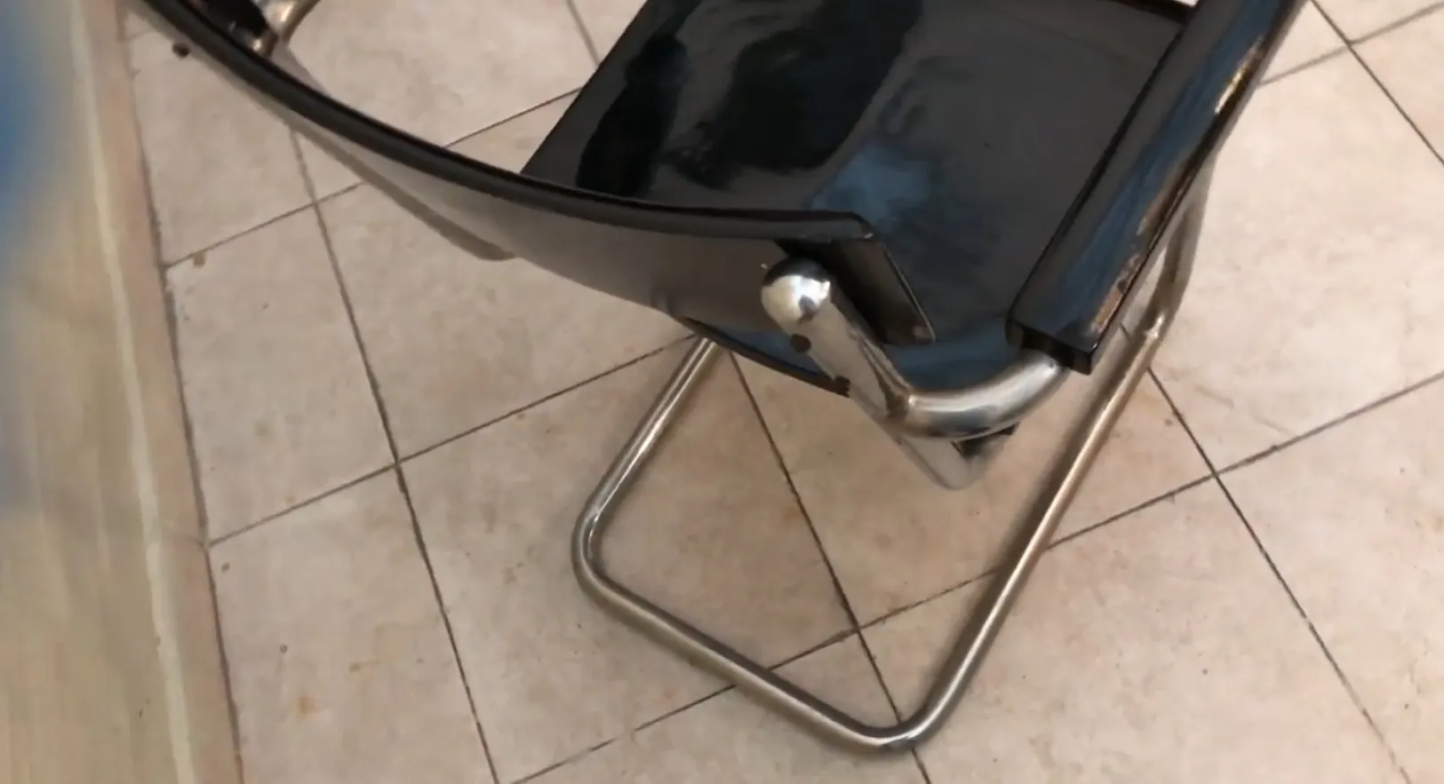 antique desk chair with black surface and metal legs