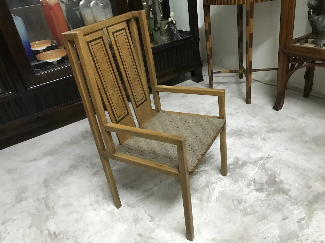 Antique desk chair with unique design in a classic setting.