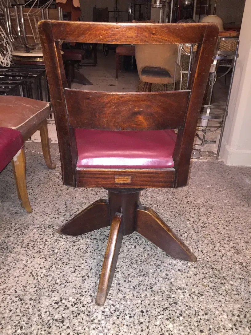 Quatre chaises de bureau anciennes dans un environnement classique.