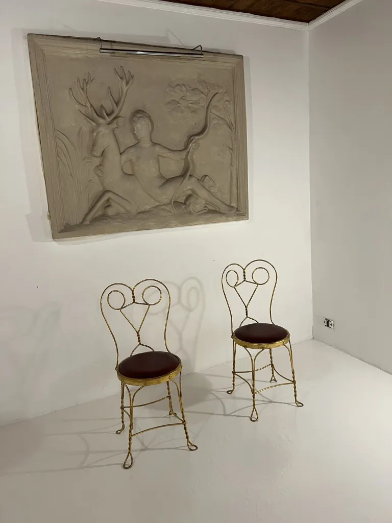 白い部屋にある装飾的な背もたれの古い椅子2脚