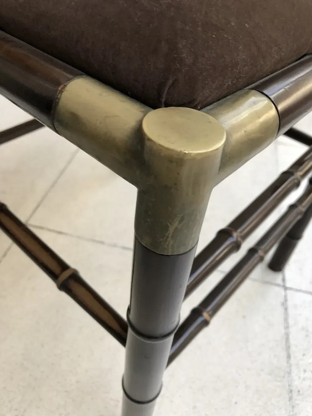 Close-up of 6 antique chairs with distinctive finishes in a neutral setting.