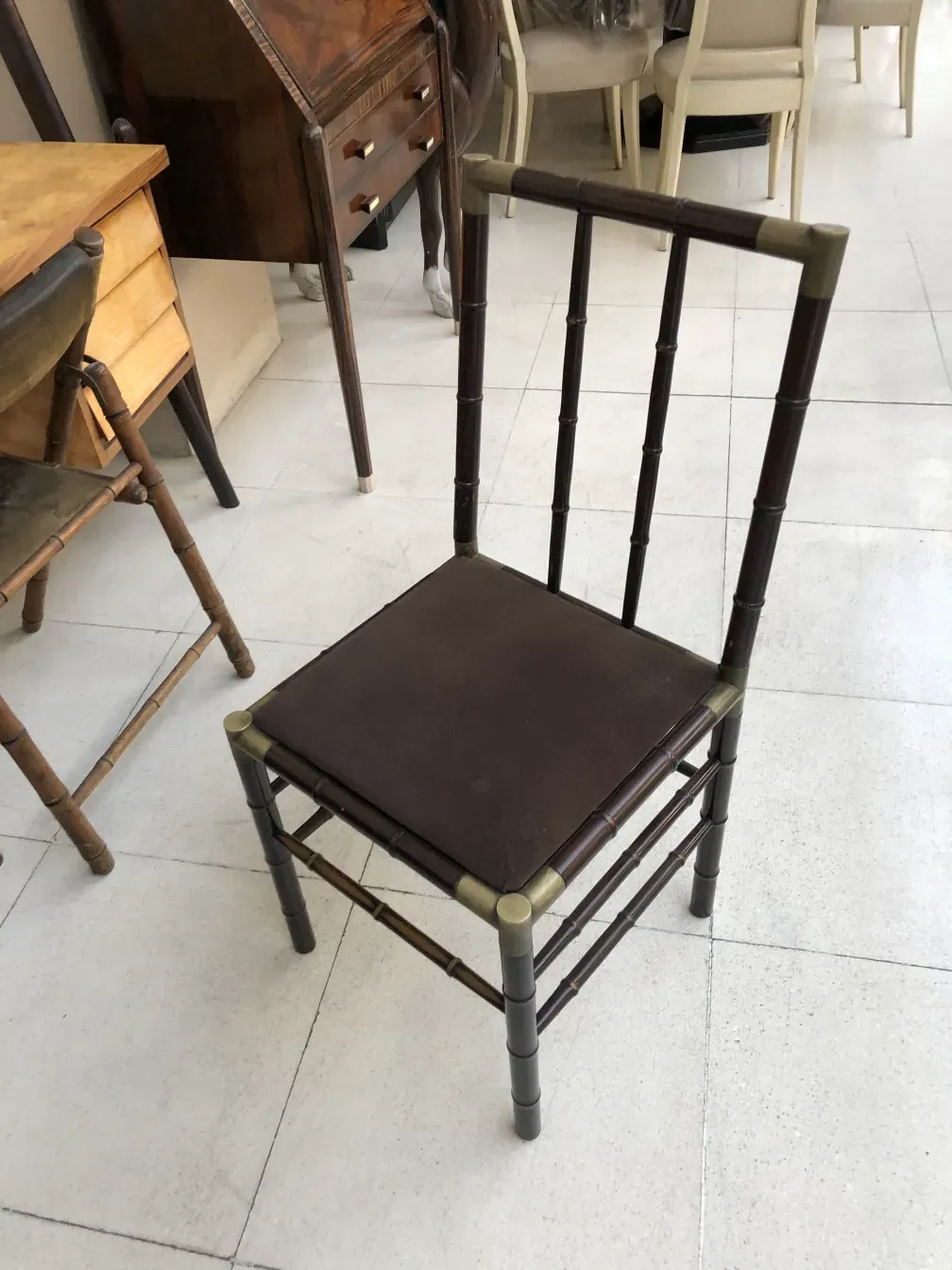 Six antique chairs arranged in an antique setting, varying positions.
